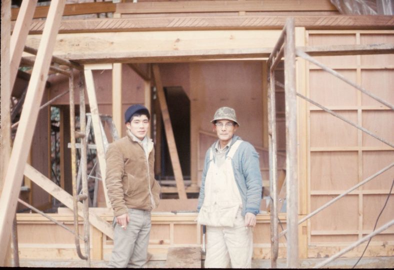 Kinya Hira (left) next to a tea house being built in Portland Japanese Garden.
