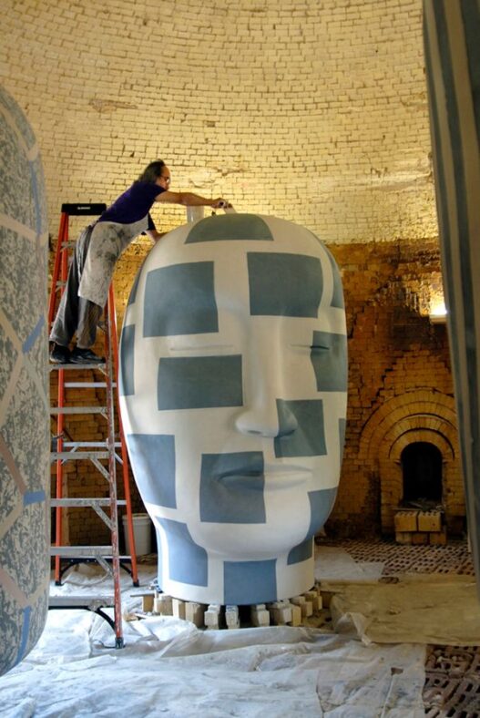 Jun Kaneko working on one of his large ceramic sculptures from his "Heads" series.