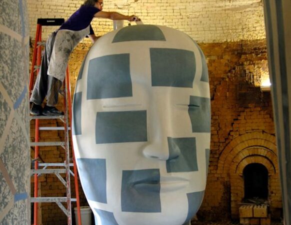 Jun Kaneko working on one of his large ceramic sculptures from his "Heads" series.