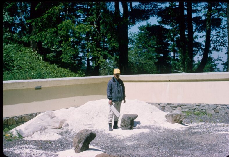 Professor Takuma Tono standing in the Sand and Stone Garden of Portland Japanese Garden during its construction.