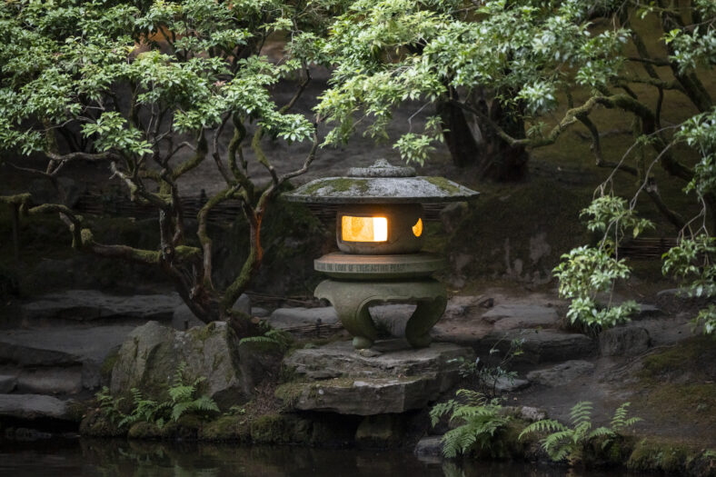 A stone lantern with a candle lit inside.