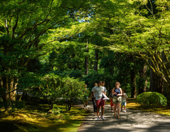 Visitors to Portland Japanese Garden walk down one of its paths in summer.