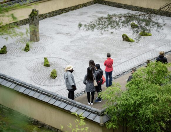 A group of Portland Japanese Garden members touring the Stone Garden.