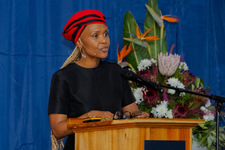 Lungi Morrison speaking at a podium in Cape Town.