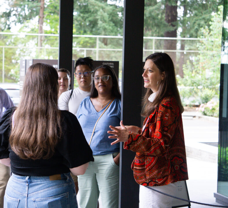 Lisa Christy talks to a group of people next to Portland Japanese Garden's Welcome Center before they head off on a tour of the Garden.