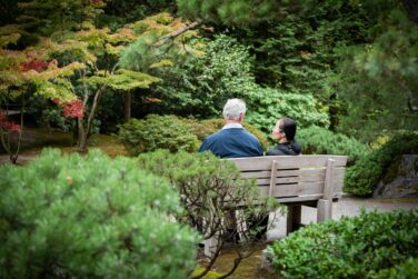 Couple sitting on a bench in the midst of the Japanese Garden