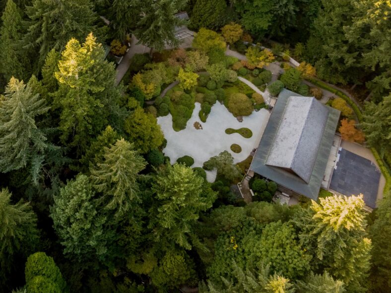 Aerial view of the Flat Garden at the Portland Japanese Garden during daytime showcasing Douglas fir trees and the Pavilion Gallery.